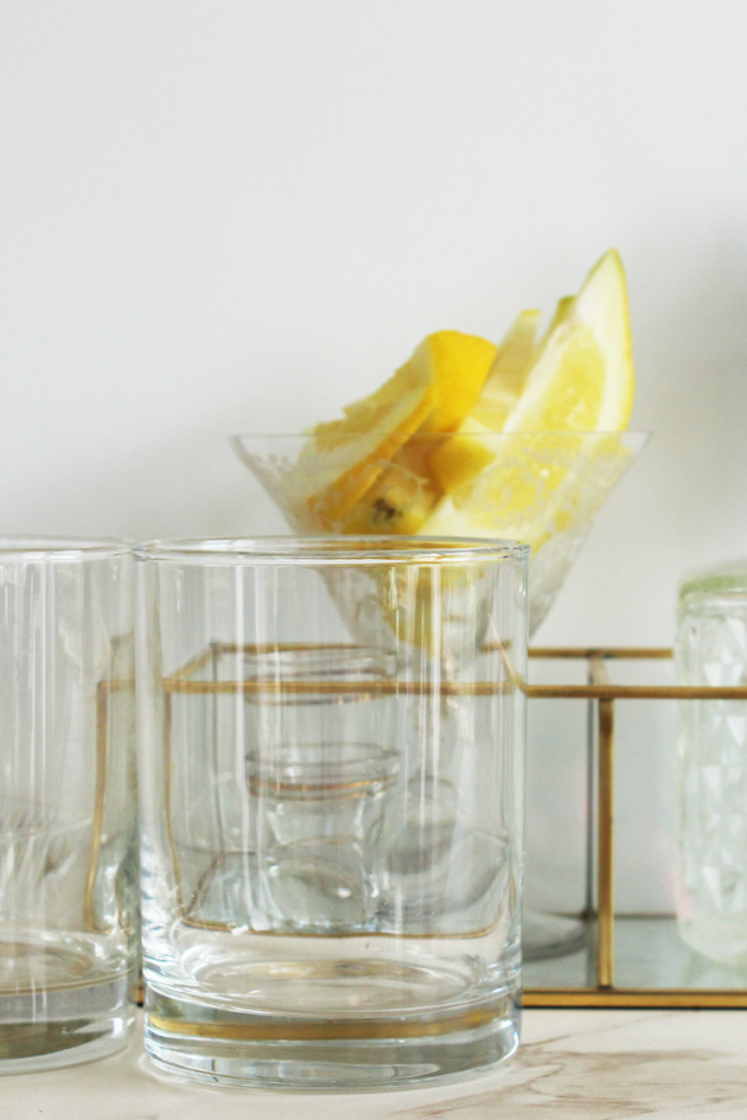 Cocktail glasses garnished with lemon- At Your Table